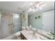Clean bathroom with a large vanity, shower, and a mirrored medicine cabinet at 9433 Harbor Greens Way # 403, Seminole, FL 33776