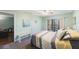 Bedroom with a queen bed, access to another room, and view of a living area at 9433 Harbor Greens Way # 403, Seminole, FL 33776
