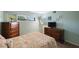 Bedroom with double bed, dresser, and a window with window shutters at 9433 Harbor Greens Way # 403, Seminole, FL 33776