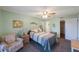 Comfortable bedroom with a striped bedspread and armchair at 9433 Harbor Greens Way # 403, Seminole, FL 33776