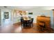 Bright dining area with wood floor and kitchen view at 9433 Harbor Greens Way # 403, Seminole, FL 33776
