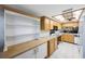 Full view of kitchen with light wood cabinets and appliances at 9433 Harbor Greens Way # 403, Seminole, FL 33776