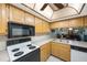 Kitchen features a breakfast bar and overlooks living room at 9433 Harbor Greens Way # 403, Seminole, FL 33776