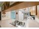 View of kitchen with light wood cabinets and appliances at 9433 Harbor Greens Way # 403, Seminole, FL 33776