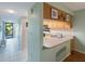 Kitchen with light cabinets, double sink, and breakfast bar at 9433 Harbor Greens Way # 403, Seminole, FL 33776