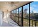 Spacious lanai with screened-in windows and a view of lush greenery at 9433 Harbor Greens Way # 403, Seminole, FL 33776