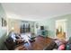 Spacious living room with hardwood floors and access to balcony at 9433 Harbor Greens Way # 403, Seminole, FL 33776