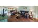 Living room with leather furniture and view of kitchen at 9433 Harbor Greens Way # 403, Seminole, FL 33776