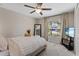 Bright bedroom with a comfortable bed, large window, and TV at 9605 Sage Creek Dr, Ruskin, FL 33573