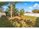 Backyard with tropical plants and a screened enclosure at 12610 Saulston Pl, Hudson, FL 34669