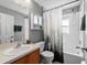 Clean bathroom with a shower/tub combo and wood vanity at 12610 Saulston Pl, Hudson, FL 34669
