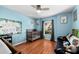 Cozy bedroom with light blue walls, wood floors, and a crib at 12610 Saulston Pl, Hudson, FL 34669