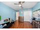 Spacious bedroom with light blue walls, wood floors, and built-in closet at 12610 Saulston Pl, Hudson, FL 34669