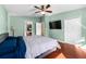 Bright bedroom with a large TV and ensuite bathroom at 12610 Saulston Pl, Hudson, FL 34669