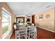 Dining area with a table and chairs, hardwood floors, and natural light at 12610 Saulston Pl, Hudson, FL 34669
