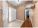 Bright entryway with tile flooring, white door, and hardwood floors at 12610 Saulston Pl, Hudson, FL 34669