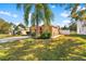 House exterior with a large yard and landscaping at 12610 Saulston Pl, Hudson, FL 34669