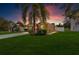 House exterior with a yard at dusk at 12610 Saulston Pl, Hudson, FL 34669