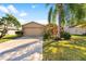 House exterior with a two-car garage at 12610 Saulston Pl, Hudson, FL 34669