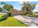 House exterior with a driveway and landscaping at 12610 Saulston Pl, Hudson, FL 34669