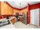 Well-equipped kitchen, featuring stainless steel appliances and wood cabinets at 12610 Saulston Pl, Hudson, FL 34669