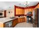 Modern kitchen with stainless steel appliances and a breakfast bar at 12610 Saulston Pl, Hudson, FL 34669