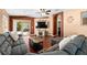 Living Room with hardwood floors, sectional sofa, and access to the backyard at 12610 Saulston Pl, Hudson, FL 34669