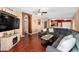 Living room with hardwood floors, sectional sofa, and entertainment center at 12610 Saulston Pl, Hudson, FL 34669