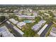 Aerial view of community, featuring multiple buildings, swimming pool, and lush landscaping at 1403 Cordova Grn, Seminole, FL 33777
