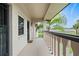 Covered balcony with a view of tropical landscaping at 1403 Cordova Grn, Seminole, FL 33777