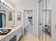 Bathroom with a double vanity, mirror and access to a toilet and shower at 1403 Cordova Grn, Seminole, FL 33777