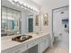 Bathroom with double vanity, large mirror, and a separate toilet area at 1403 Cordova Grn, Seminole, FL 33777