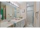 Bright bathroom with double vanity, shower, and updated fixtures at 1403 Cordova Grn, Seminole, FL 33777