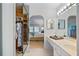 Bathroom with double vanity and mirrored closet at 1403 Cordova Grn, Seminole, FL 33777