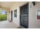 Condo entry with two doors, security bars, and a shared hallway at 1403 Cordova Grn, Seminole, FL 33777