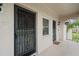 Condo entry with two doors, security bars, and a shared hallway at 1403 Cordova Grn, Seminole, FL 33777