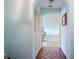 Hallway with light blue walls, terracotta tile flooring, and access to rooms at 1403 Cordova Grn, Seminole, FL 33777