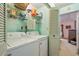 Laundry room with washer, dryer, and ample storage shelving at 1403 Cordova Grn, Seminole, FL 33777