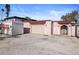 Pink stucco house with a large garage and gated entryway at 14971 1St E St, Madeira Beach, FL 33708