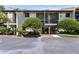 Two-story building exterior with landscaping and parking at 1515 Pinellas Bayway S # 45, St Petersburg, FL 33715