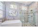 Spa-like bathroom with freestanding tub, walk-in shower, and elegant tile at 1610 Brilliant Cut Way, Valrico, FL 33594