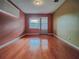 Bedroom with hardwood floors and two windows at 19329 Autumn Woods Ave, Tampa, FL 33647