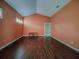 Spacious bedroom with dark hardwood floors and coral walls at 19329 Autumn Woods Ave, Tampa, FL 33647