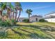 Sunny backyard with grassy area and home view at 219 Leeward Is, Clearwater Beach, FL 33767