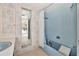 Light blue bathroom with shower and bathtub, needs updating at 219 Leeward Is, Clearwater Beach, FL 33767