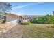 Single-story house with attached garage and well-maintained lawn at 219 Leeward Is, Clearwater Beach, FL 33767