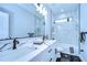 Clean bathroom with marble shower and double vanity at 2308 1/2 Saint Louis, Tampa, FL 33607