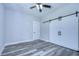 Bedroom with gray flooring, white barn doors, and ceiling fan at 2308 1/2 Saint Louis, Tampa, FL 33607