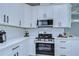 Modern kitchen corner with white cabinets and stainless steel appliances at 2308 1/2 Saint Louis, Tampa, FL 33607