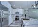 Modern kitchen with white cabinets, stainless steel appliances, and quartz countertops at 2308 1/2 Saint Louis, Tampa, FL 33607